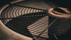 Close-up view of the metal grille and central hub of an industrial fan or ventilation unit.